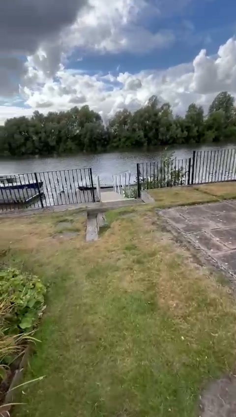Finished riverside garden with reinstated lawn looking out over the water