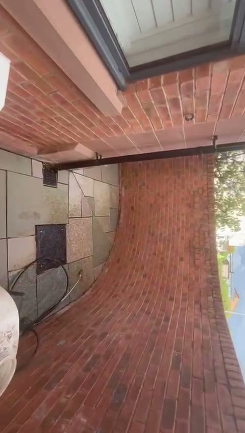 Finished brick-paved side passage running alongside the house