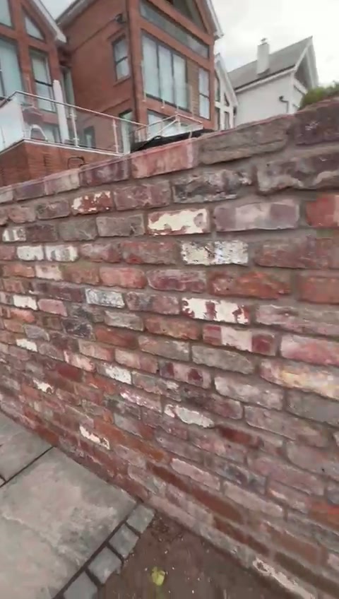 Finished side passage with flag paving between the house and boundary wall