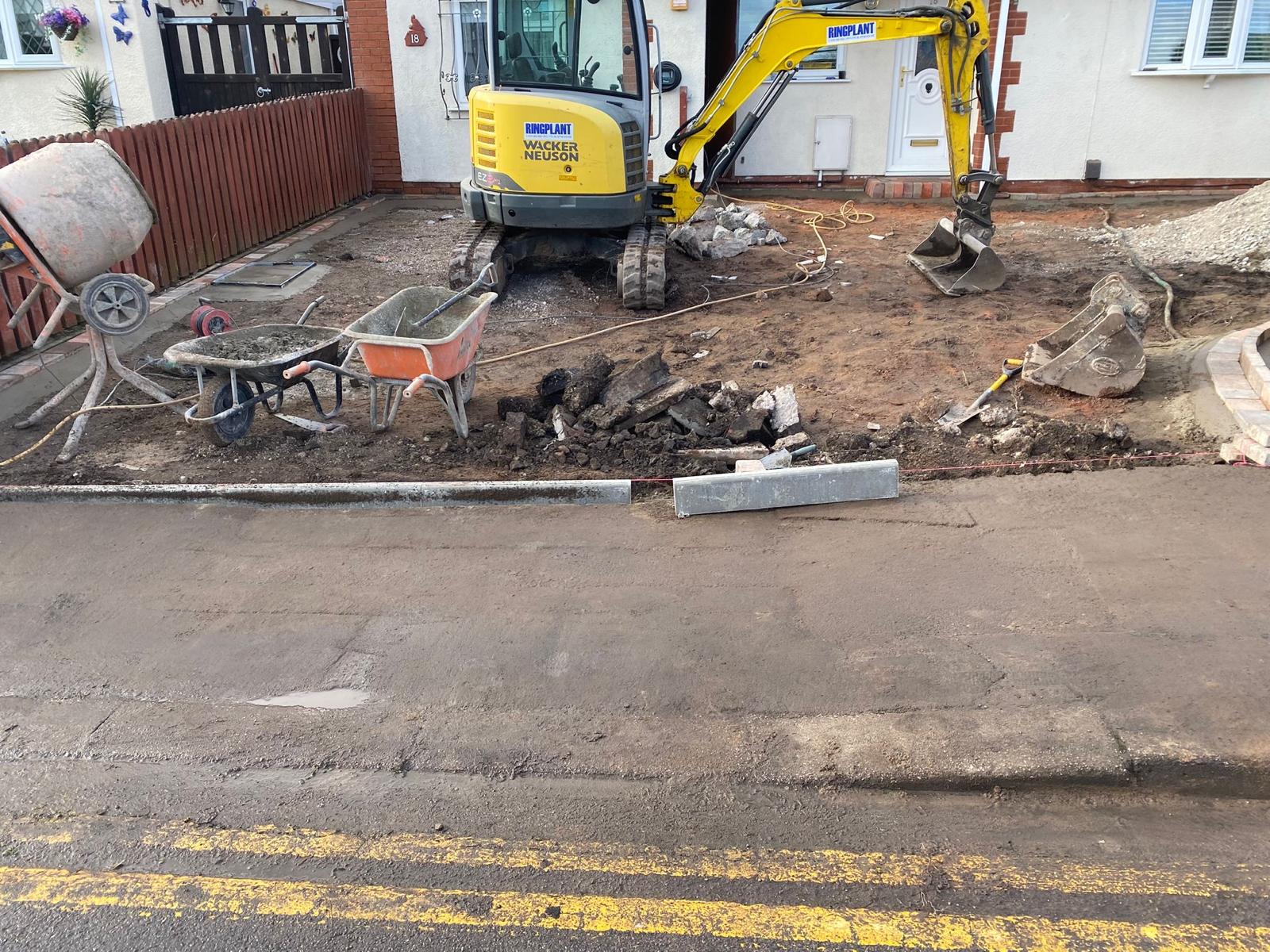 Excavator carrying out groundworks for a bungalow extension