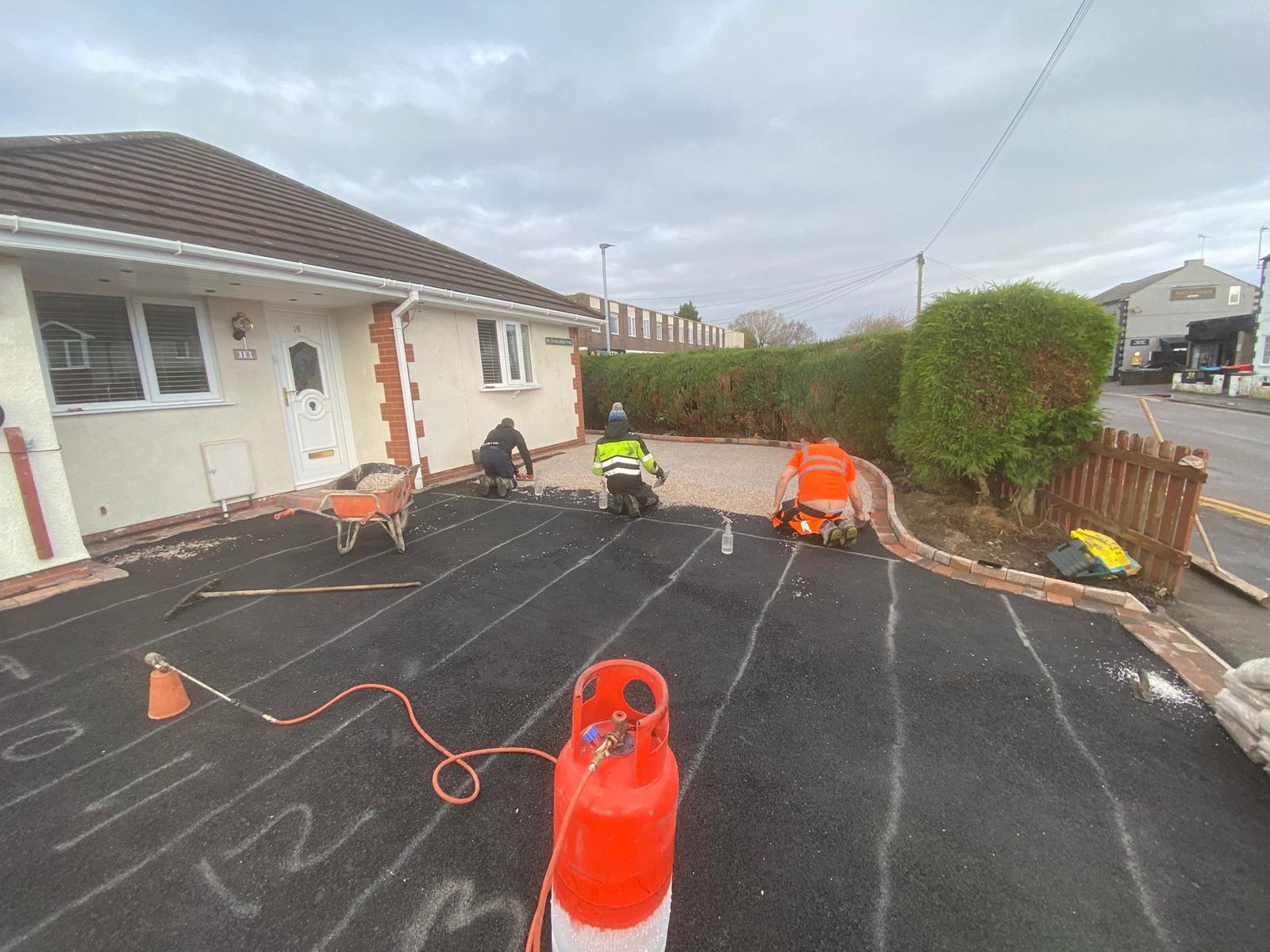 New tarmac base laid and marked out across a bungalow front driveway