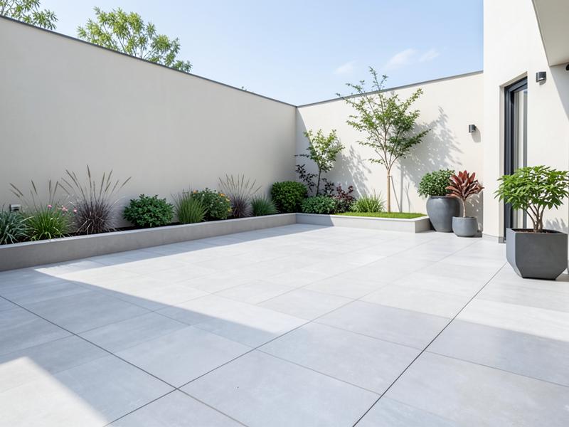 Modern patio laid with light grey porcelain paving slabs